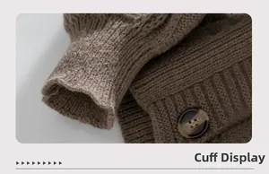 Macro view of brown chunky knit cardigan cuff with tortoiseshell button detail