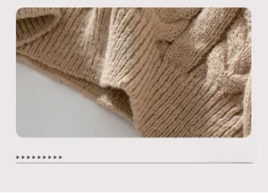 Detail of the cable knit pattern and ribbed hem on this khaki hooded sweater top