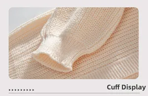 Macro detail of the ribbed cuff on a cream knit cardigan showing soft fabric texture