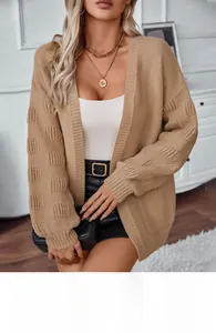Detail of khaki chunky knit cardigan showing thick textured pattern and ribbed cuffs