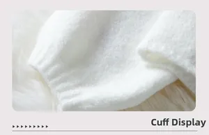 Close-up of white plush knit sweater cuff showing soft fuzzy texture and warm material