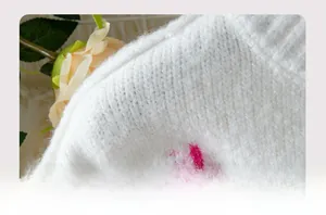 Close-up of white knit sweater fabric texture with soft purple star pattern details