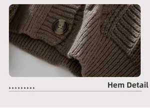 Detailed view of brown cable knit cardigan hem with a marble textured button