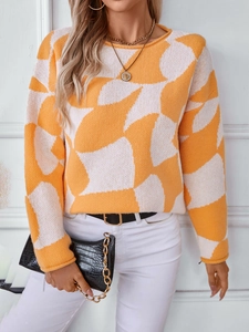 Women's oversized orange and white contrast color knit sweater with geometric pattern