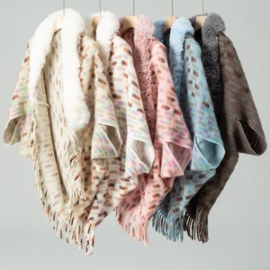 Close-up of knit cardigans with faux fur collars and tassels in various colors