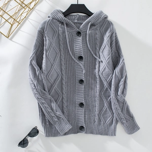 Detail of grey cable knit cardigan with hood and diamond pattern texture details