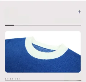 Detailed view of the contrast white ribbed crewneck on a blue knit sweater