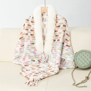 Macro shot of faux fur collar and geometric knit texture on fringed women shawl
