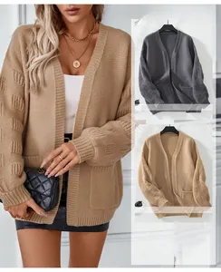 Detail of raised geometric block texture on long sleeve knit cardigan in grey and khaki