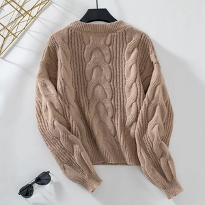 Close-up of the cable knit texture on the back of this khaki oversized sweater