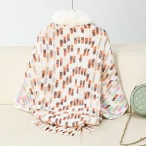 Close-up of geometric knit shawl with plush faux fur collar and fringe tassels