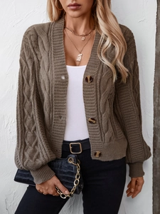 Detailed view of brown cable knit cardigan with amber-textured buttons and knit patterns
