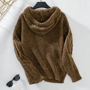 Close-up of brown hooded knit cardigan showing detailed cable knit texture and ribbed cuffs