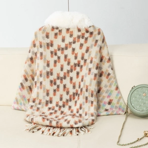 Detail of knit shawl featuring white faux fur collar and geometric block pattern fringe
