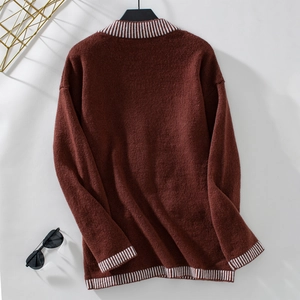 Detail view of the rust-red knitted sweater back with white striped ribbed collar and hem
