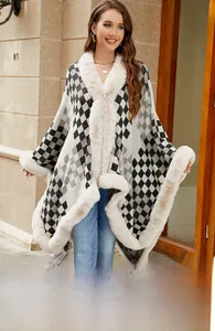 Detail of elegant argyle knit poncho featuring thick beige faux fur trim and collar