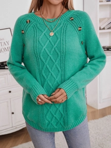 Loose mint green cable knit sweater with decorative buttons and classic raglan sleeves
