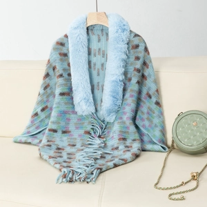 Detail of blue knitted shawl featuring faux fur collar and vibrant abstract pattern