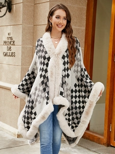 Detailed knit texture of a thick winter shawl with beige faux fur trim and checkers