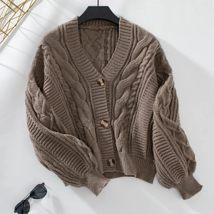 Macro detail of dark brown cable knit cardigan with vintage amber buttons and V-neckline