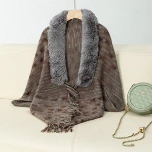 Close-up of knit shawl featuring soft faux fur collar and elegant fringe hem details