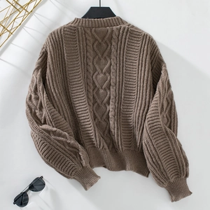 Detail of coffee brown cable knit cardigan featuring premium texture and ribbed hem