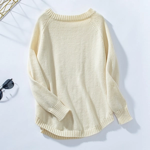 Detailed view of the ribbed round neckline and soft texture of an ivory knitted sweater