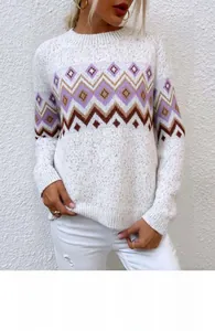 Close-up of geometric knit patterns on a beige long-sleeved crewneck sweater