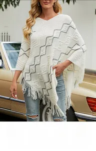 Detail of chevron knit poncho with pearl embellishments and fringe tassels on a model