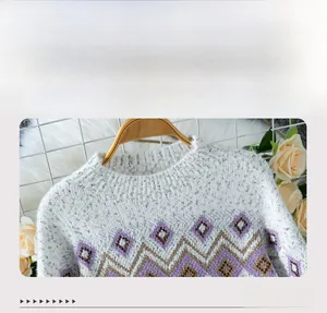 Detail of the crew neck collar featuring purple and grey jacquard knit patterns on sweater