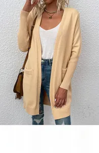 Detail of apricot long knit cardigan with side pockets and ribbed cuffs texture