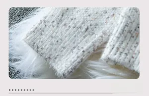 Detail of knit sweater cuff with ribbed texture and white faux fur trim decoration