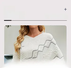 Detail of V-neck white knit sweater with gray zigzag stitching and pearl embellishments