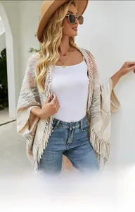 Detail of knit stripe shawl with long tassel fringe and soft multicolored texture