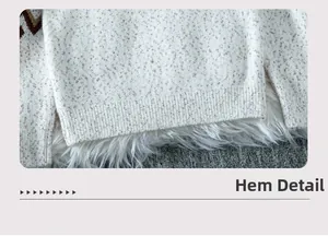Detail view of the ribbed hem and soft speckled knit texture on an oatmeal sweater