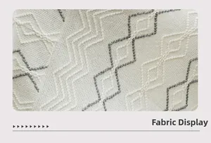 Detailed macro view of bohemian knit fabric with white and gray geometric embroidery
