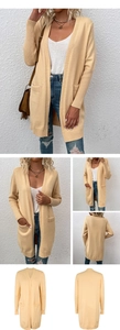 Detail view of ribbed cuffs and functional side pockets on a beige knitted cardigan