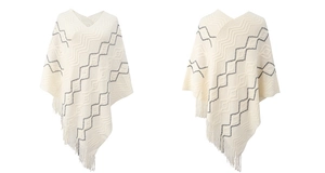 Close-up of chevron knit pattern and fringe detail on minimalist ivory poncho cape