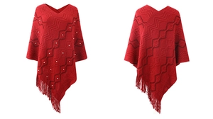 Detailed view of red knitted poncho with pearl beads and wave patterns and fringe
