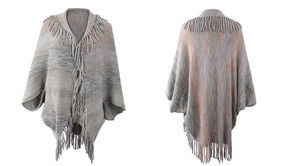 Detail view of grey knit poncho with colorful accents and bohemian fringe hem finish