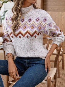 Detail of bohemian geometric jacquard patterns on beige knit sweater with soft texture