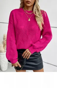 Close-up of chunky cable knit texture on magenta oversized long-sleeved sweater