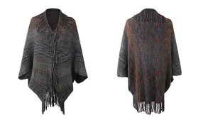 Detail of bohemian knit shawl featuring mixed colored yarn and long tassel hemline