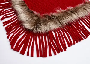 Detail of red knit shawl featuring brown faux fur trim and long tassel fringe craftsmanship