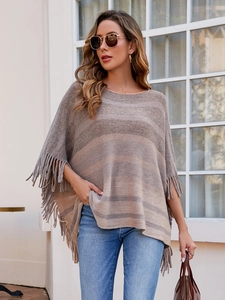Detail of bohemian knit shawl featuring contrasting earth tone stripes and fringe tassels