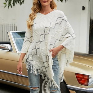 White knit bohemian poncho with grey zigzag patterns, pearl accents and long tassel edges