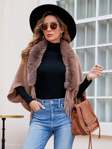 Brown knitted poncho with faux fur collar and fringe tassels for autumn and winter