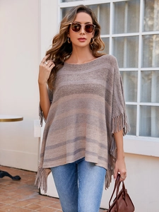 Detail of round neck knit poncho featuring earth-tone stripes and fringe trim