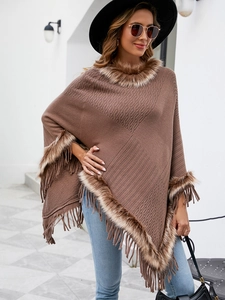 Detail of coffee brown knit poncho featuring thick faux fur trim and dense fringe edges