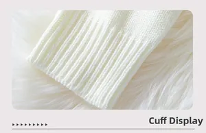 Detail of ribbed cuffs on a white knitted sweater showing fine knitwear texture and quality
